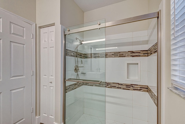 bathroom with a shower with shower door