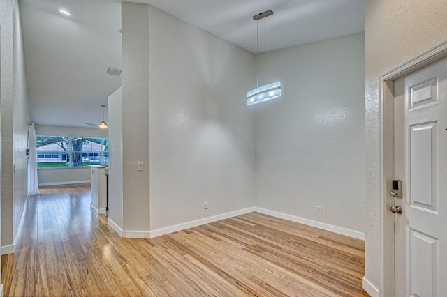 foyer entrance featuring ceiling fan and wood-type flooring