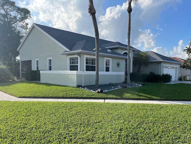 ranch-style house featuring a garage and a front lawn