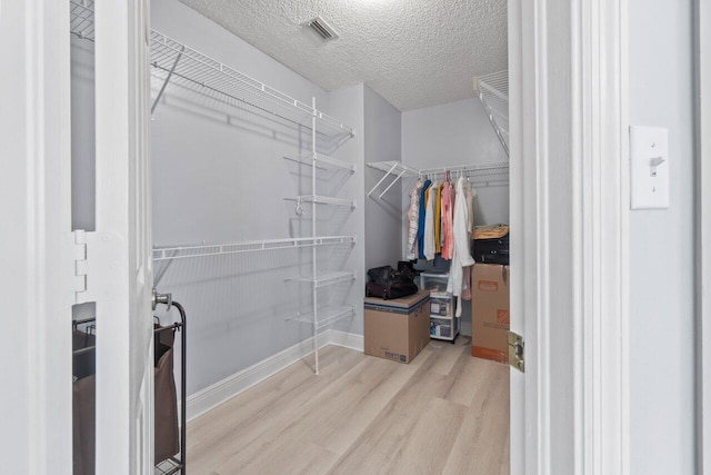 spacious closet featuring light wood-type flooring