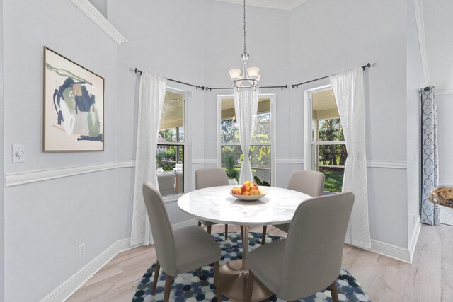 kitchen with white cabinetry, an island with sink, appliances with stainless steel finishes, and crown molding