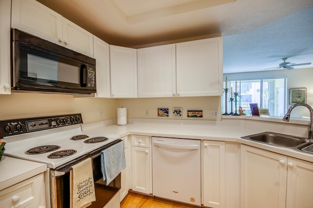 kitchen featuring sink, white appliances, ceiling fan, white cabinetry, and a textured ceiling