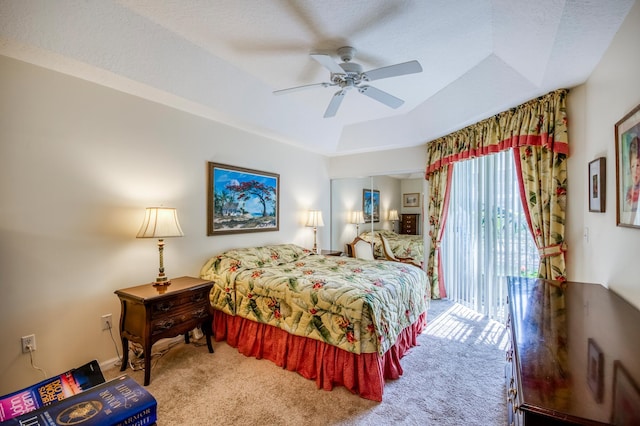 bedroom featuring carpet floors, a raised ceiling, ceiling fan, and access to outside