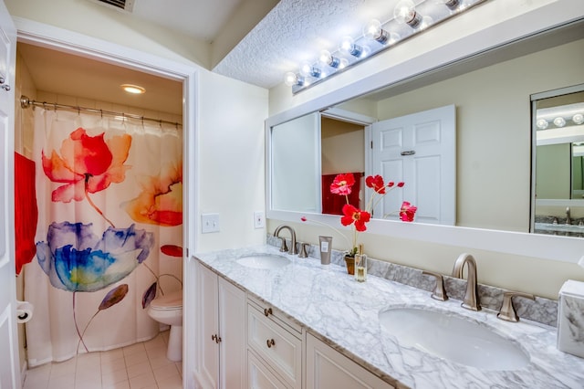 bathroom with a shower with curtain, vanity, toilet, and tile patterned flooring