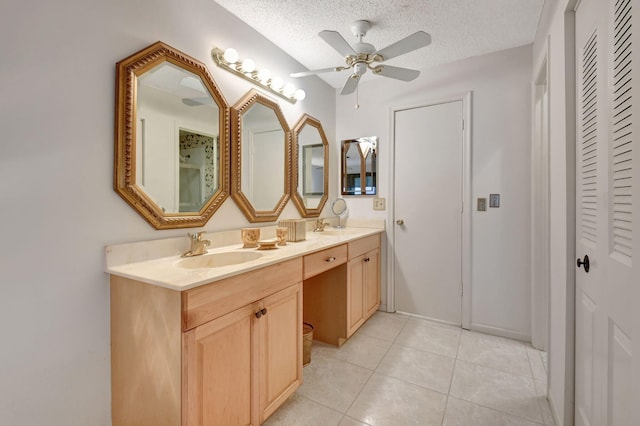 bathroom featuring tile patterned flooring, vanity, ceiling fan, and a textured ceiling