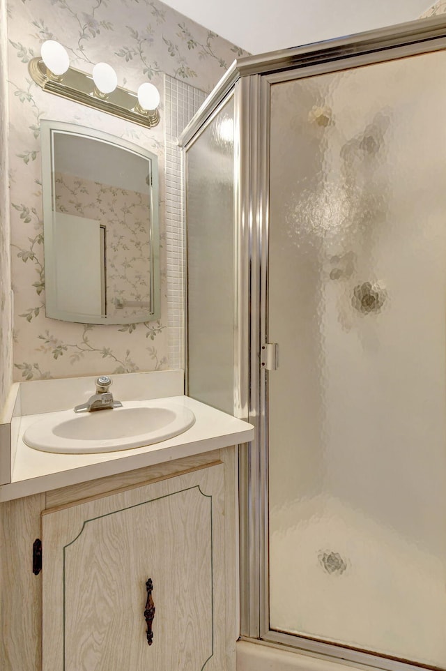 bathroom featuring vanity and an enclosed shower