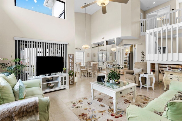 tiled living room featuring ceiling fan with notable chandelier