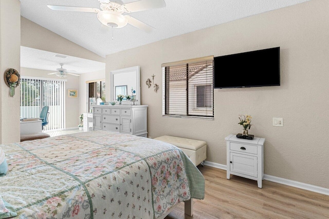 bedroom with vaulted ceiling, a textured ceiling, access to outside, light wood-type flooring, and ceiling fan