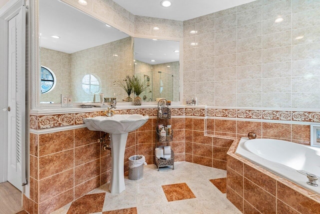 bathroom with independent shower and bath and tile walls