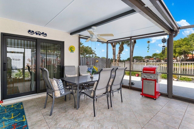 sunroom with beamed ceiling and ceiling fan