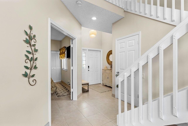 tiled entrance foyer with a textured ceiling