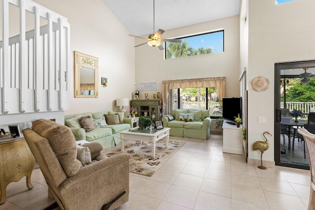 living room featuring light tile patterned floors, a textured ceiling, and ceiling fan