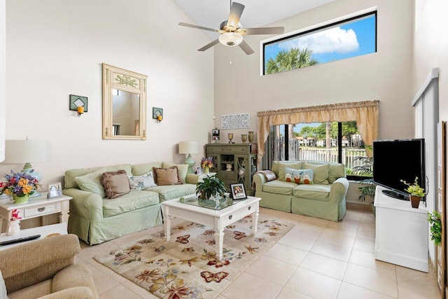 tiled living room with a towering ceiling and ceiling fan