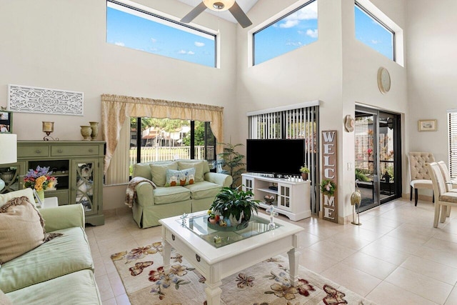 living room featuring light tile patterned floors and ceiling fan