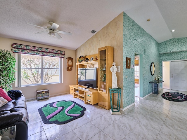 tiled living room featuring lofted ceiling, ceiling fan, and a textured ceiling