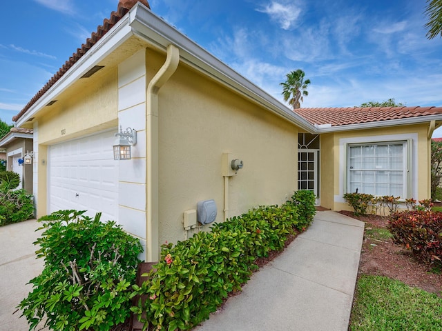 view of side of property with a garage