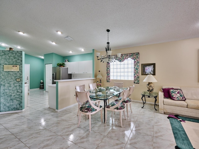 unfurnished dining area with a textured ceiling and a chandelier