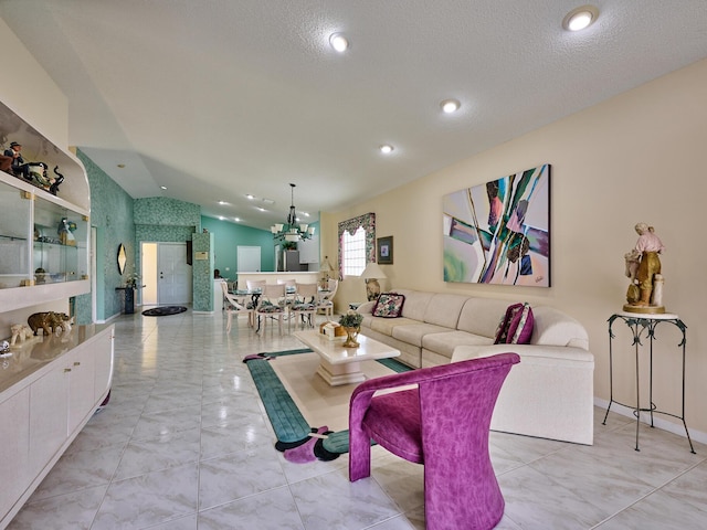 living room featuring lofted ceiling, a textured ceiling, and a notable chandelier