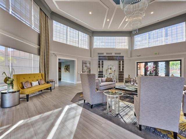 living room featuring an inviting chandelier and a high ceiling