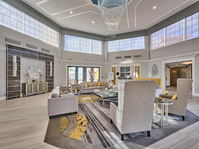 living room featuring coffered ceiling, an inviting chandelier, crown molding, hardwood / wood-style floors, and a high ceiling