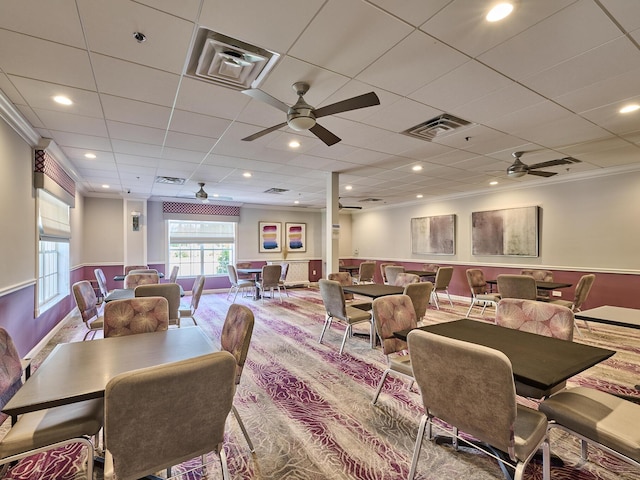 dining room with ornamental molding and a paneled ceiling