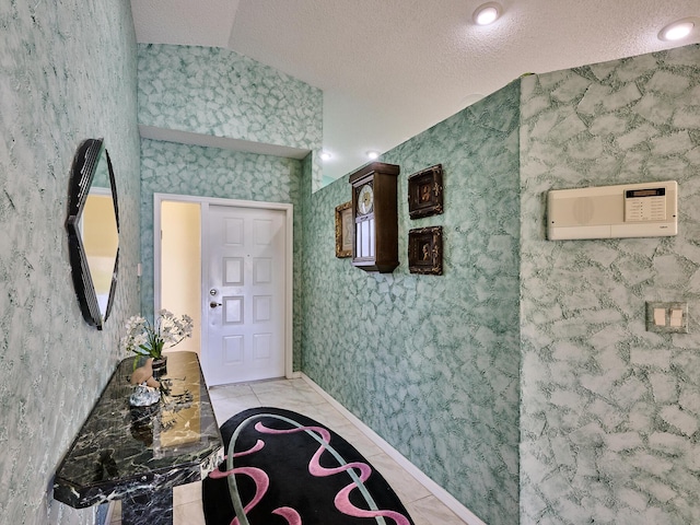 hallway featuring lofted ceiling and a textured ceiling