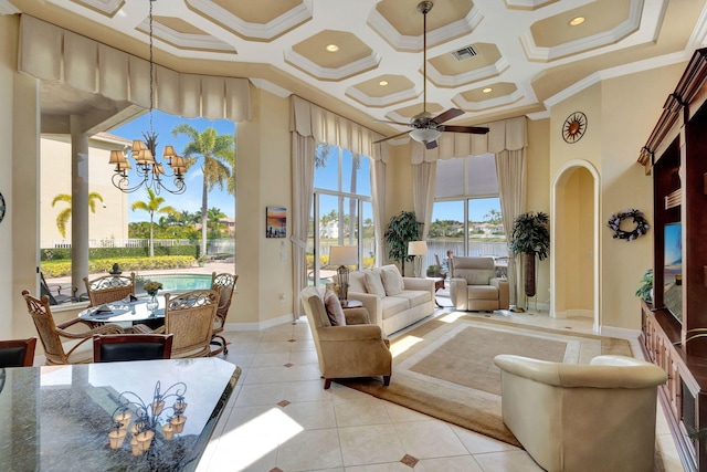 living room with light tile patterned flooring, ceiling fan with notable chandelier, a high ceiling, ornamental molding, and coffered ceiling