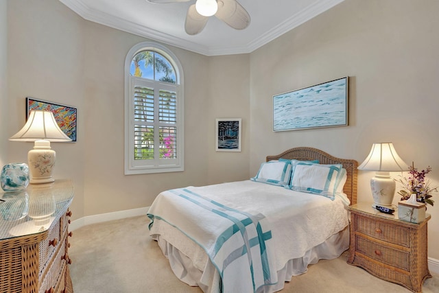 carpeted bedroom featuring crown molding and ceiling fan