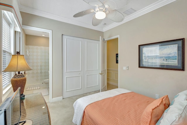 bedroom featuring ensuite bathroom, crown molding, light carpet, a closet, and ceiling fan