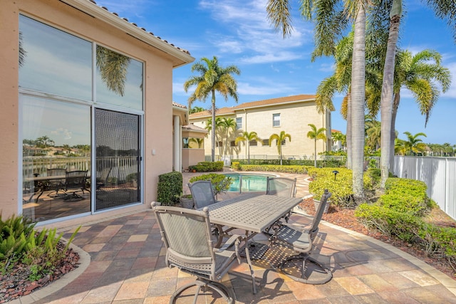 view of patio / terrace with a fenced in pool