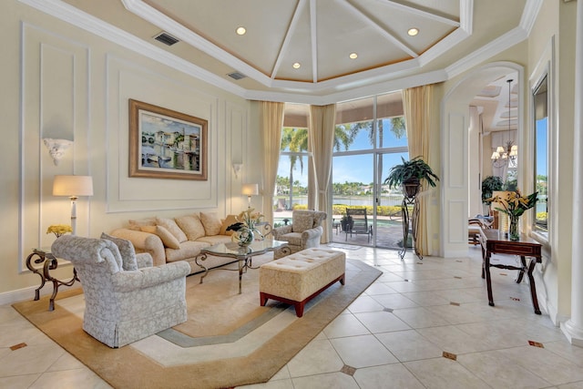 tiled living room with crown molding, a towering ceiling, and an inviting chandelier