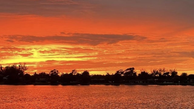 nature at dusk featuring a water view