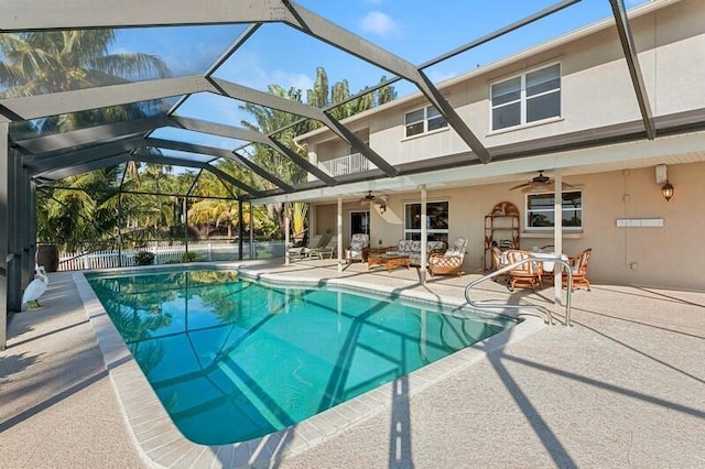 outdoor pool featuring a ceiling fan, a lanai, and a patio