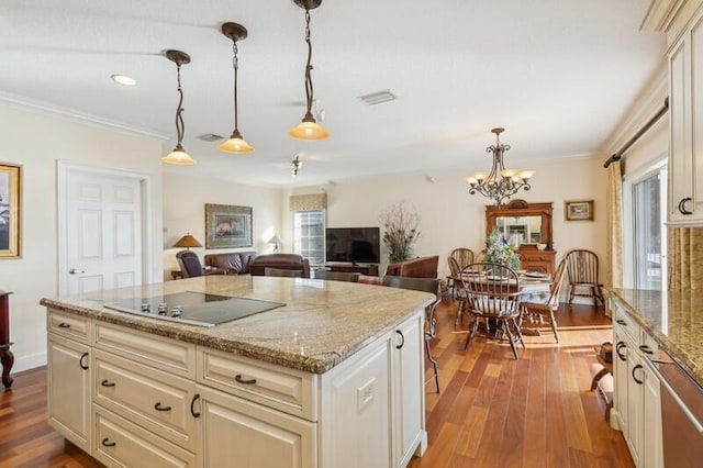 kitchen featuring black electric stovetop, pendant lighting, wood finished floors, and ornamental molding