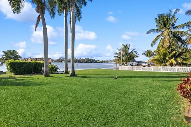 view of yard featuring a water view and fence