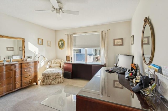 carpeted home office featuring ceiling fan