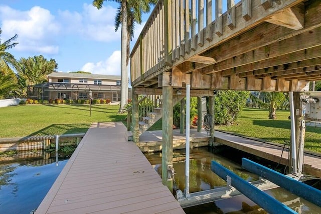 view of dock featuring stairs and a yard