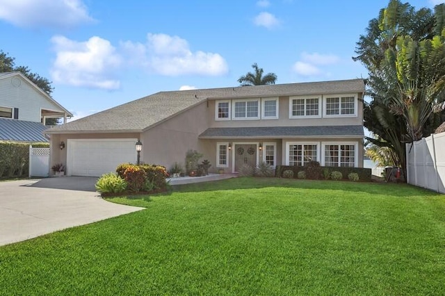 view of front of home featuring an attached garage, fence, concrete driveway, stucco siding, and a front lawn