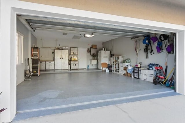 garage featuring freestanding refrigerator and white fridge