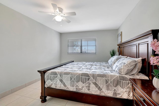 bedroom featuring light tile patterned floors, baseboards, and ceiling fan