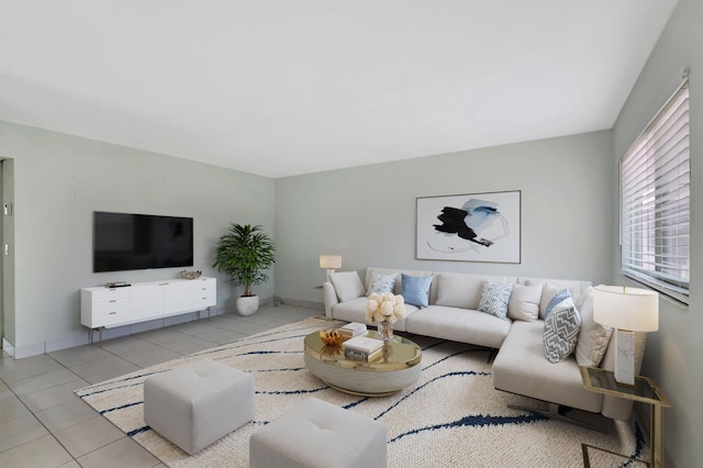 living area featuring tile patterned floors and baseboards
