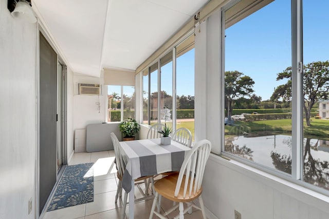 sunroom / solarium with a wall mounted air conditioner and a water view