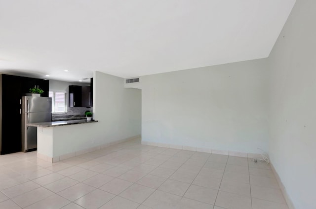 unfurnished living room featuring recessed lighting, light tile patterned flooring, baseboards, and visible vents