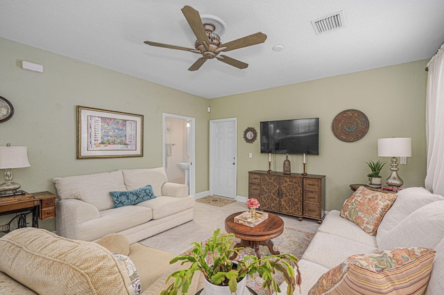 tiled living room featuring ceiling fan