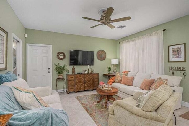 tiled living room featuring ceiling fan