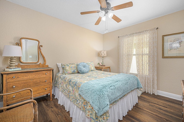 bedroom with dark wood-type flooring and ceiling fan