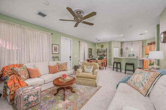 living room featuring ceiling fan and light tile patterned flooring