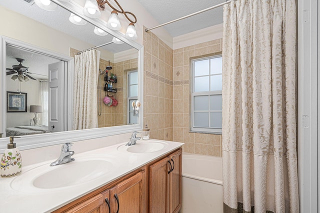 bathroom featuring shower / bath combo, ceiling fan, vanity, and a textured ceiling