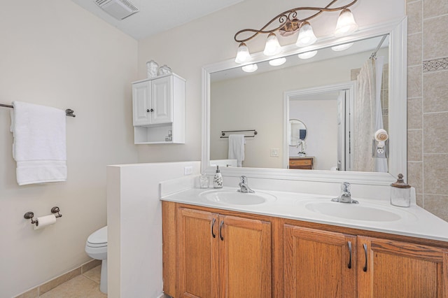 bathroom with vanity, tile patterned floors, and toilet