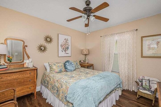 bedroom with ceiling fan and dark hardwood / wood-style flooring